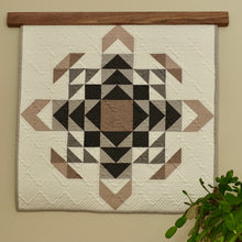 Load image into Gallery viewer, Pictured is our Walnut Natural Hardwood Quilt Hanger, 2 inches longer than the wall hanging. Wallhanging is the Barton Cottage Quilt from Sara Lucille Handmade.
