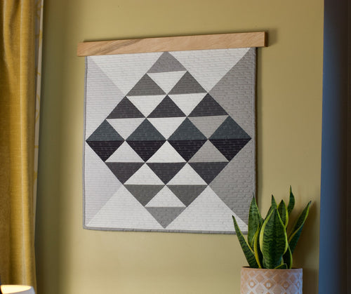  Pictured is our Maple Natural Hardwood Quilt Hanger, 2 inches longer than the  wall hanging. Wallhanging is the Converge Quilt from Sewn Handmade.